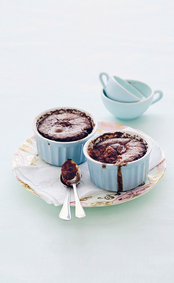 Baked chocolate and cinnamon puddings in ramekins