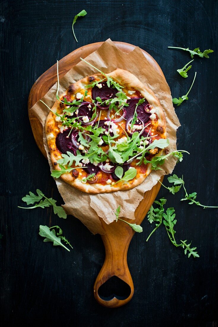 Pizza with beetroot and rocket