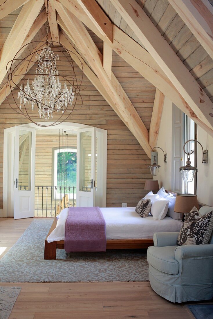 Rustic wooden roof structure in attic bedroom