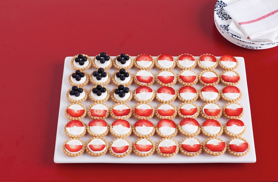 Berry fruit tarts arranged as an American flag for 4th July
