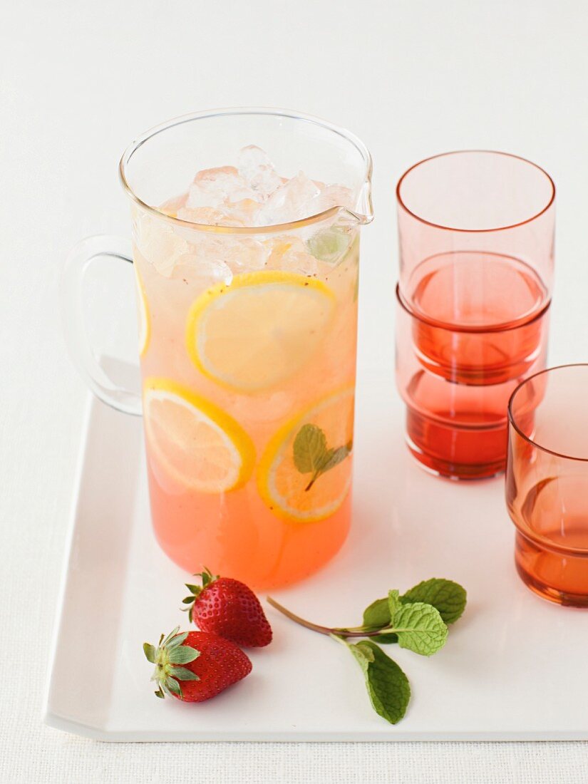 Strawberry lemonade in a glass jug