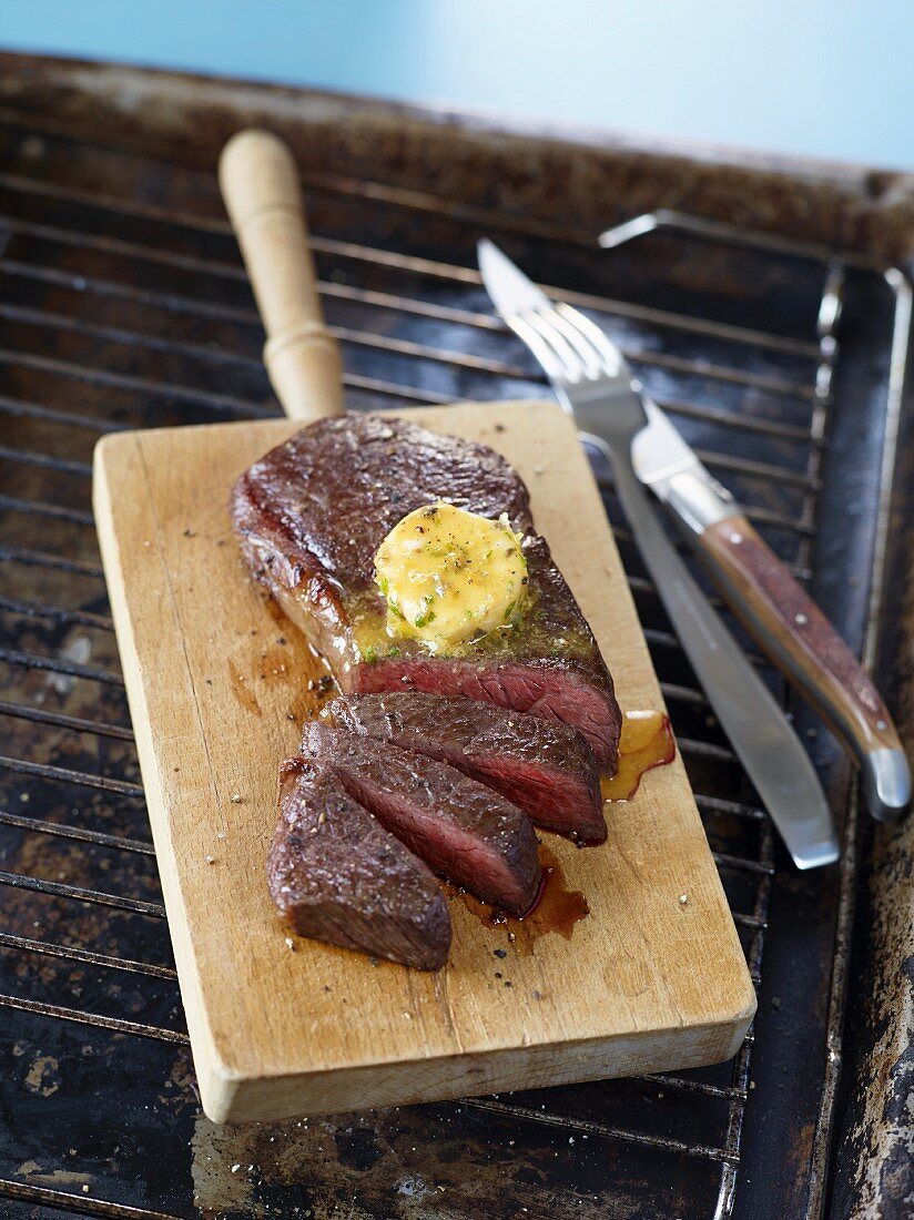 Steak with Cafe de Paris butter on a chopping board