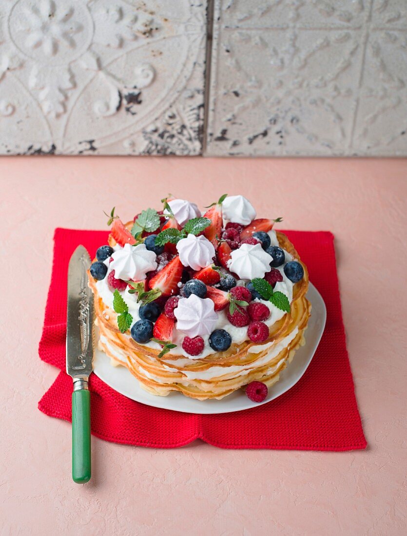 A waffle cake with berries and meringue