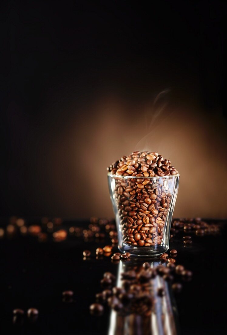 A glass of freshly roasted coffee beans