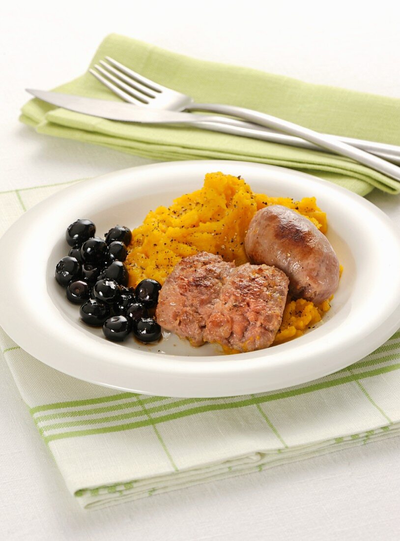 Sausages with mashed pumpkin and black olives