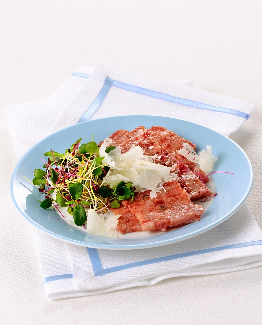 Tagliata di cotechino (raw sausage meat with shaved Parmesan, Italy)