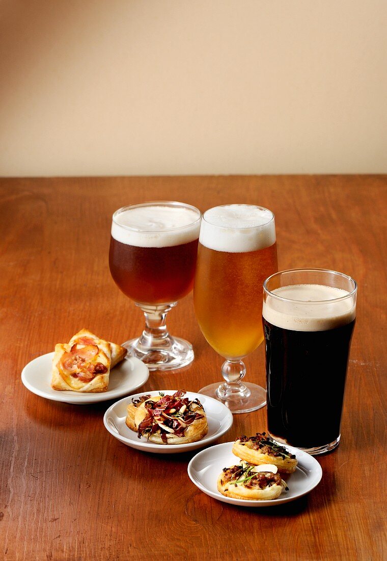 Various glasses of beer with spicy tartlets