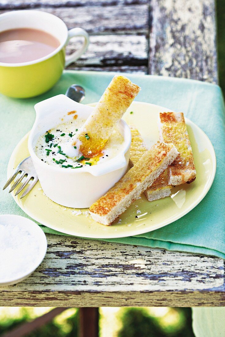 Gratinated egg with Parmesan cheese and anchovy soldiers