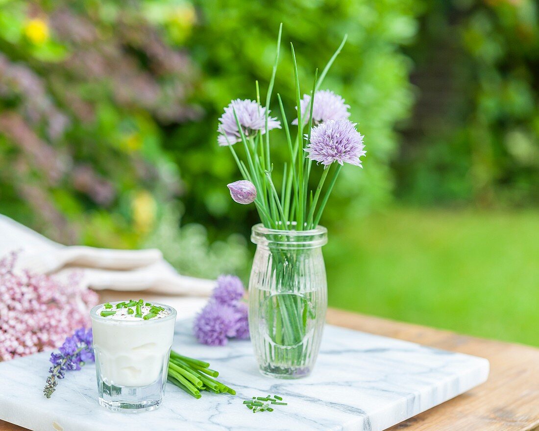 Chives and chive quark on a garden table