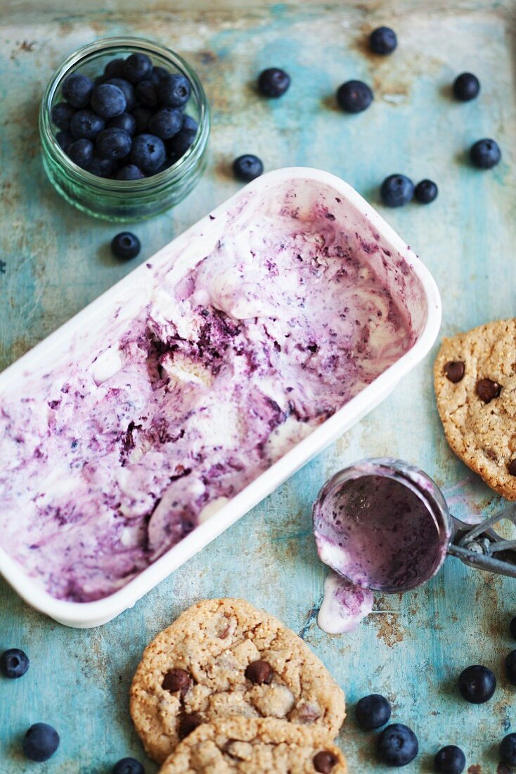 Ingredients for ice cream sandwiches with chocolate chip cookies and blueberry ice cream