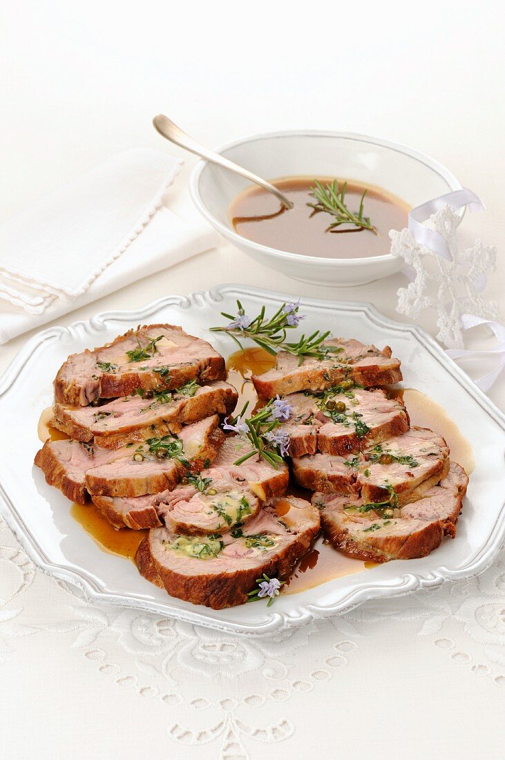 Roast veal wrapped in ham with rosemary