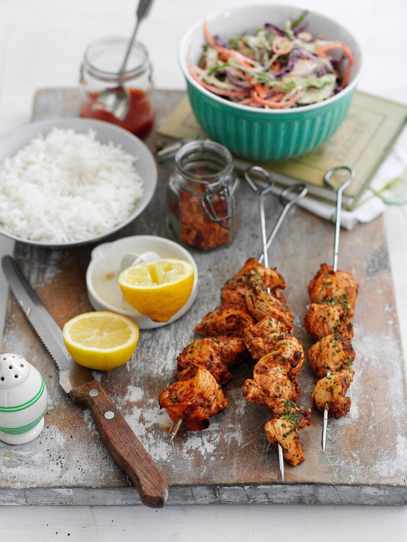 Peri-peri chicken kebabs with rice and colourful coleslaw