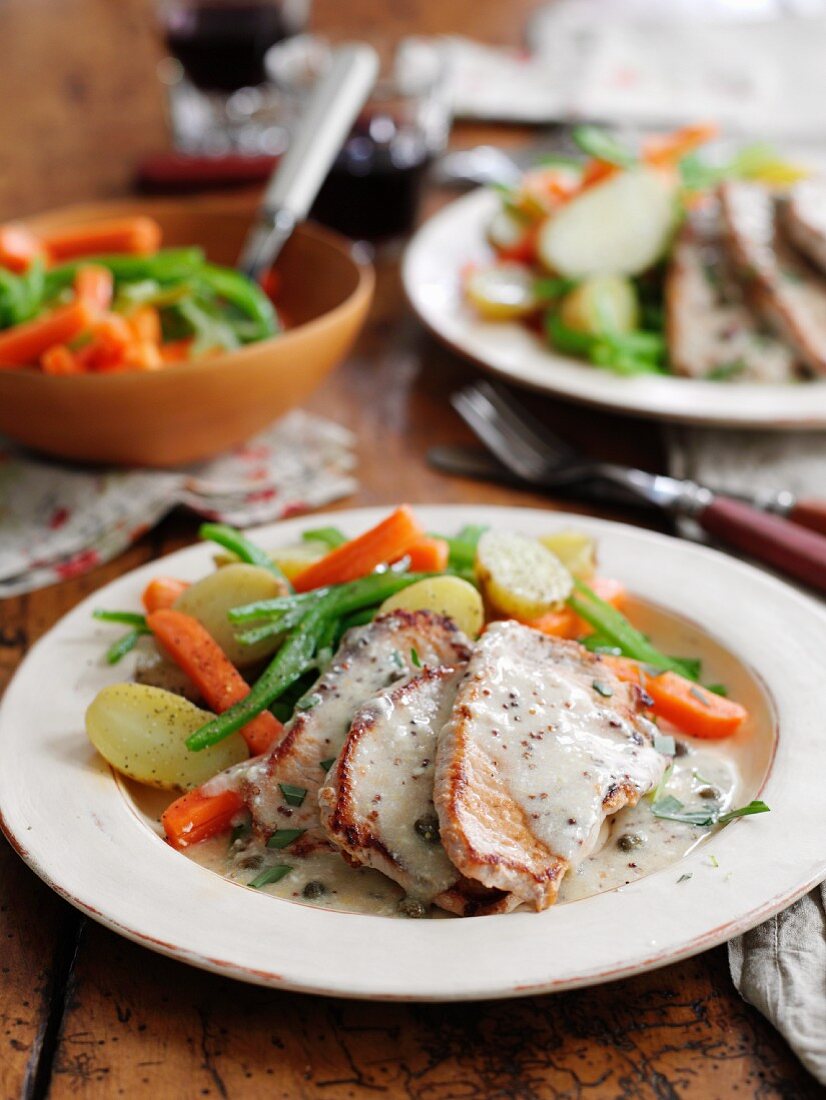 Pork escalopes with a creamy mustard and caper sauce