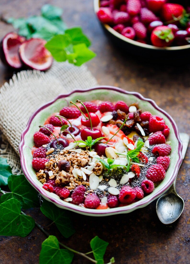 A smoothiey bowl with cherries and raspberries
