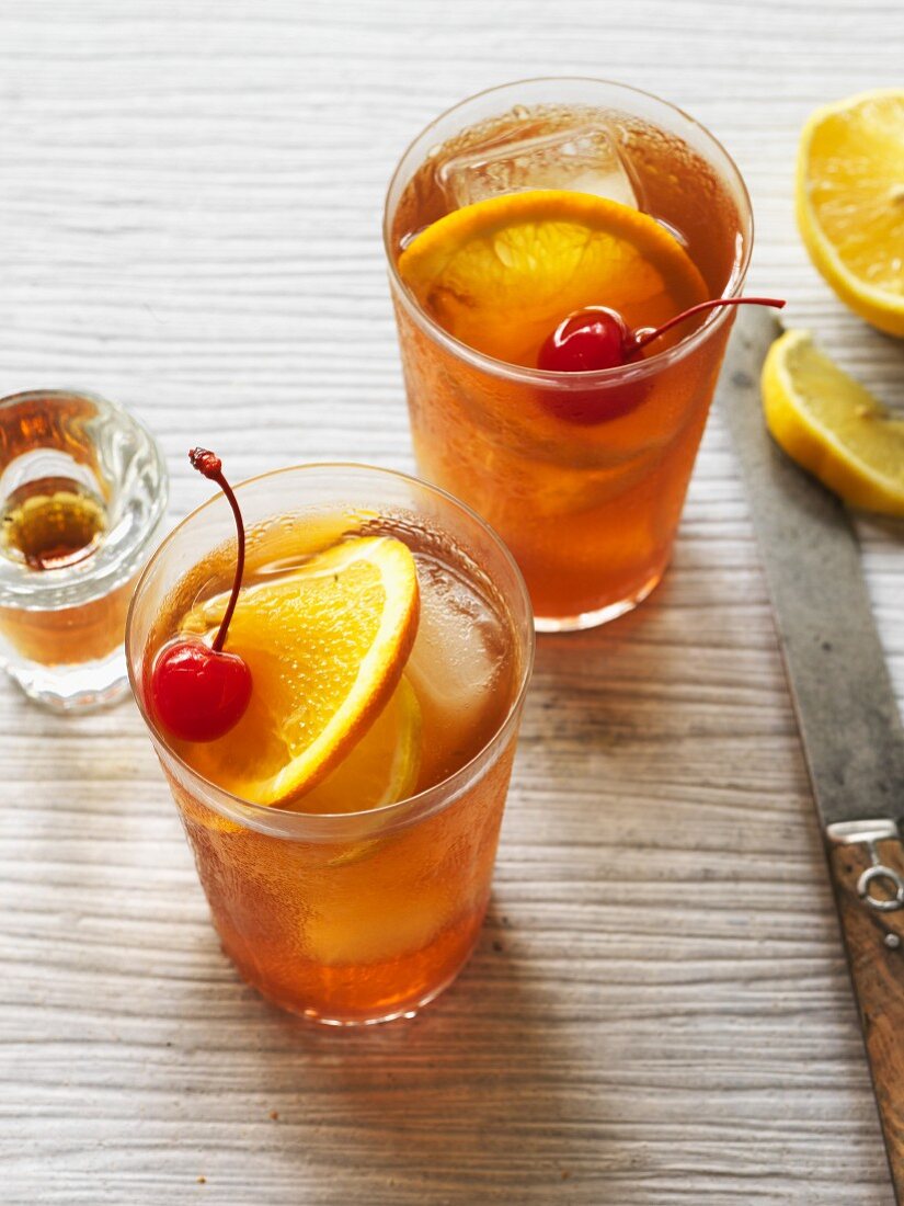 Old Fashioned Bourbon cocktails with ice cubes