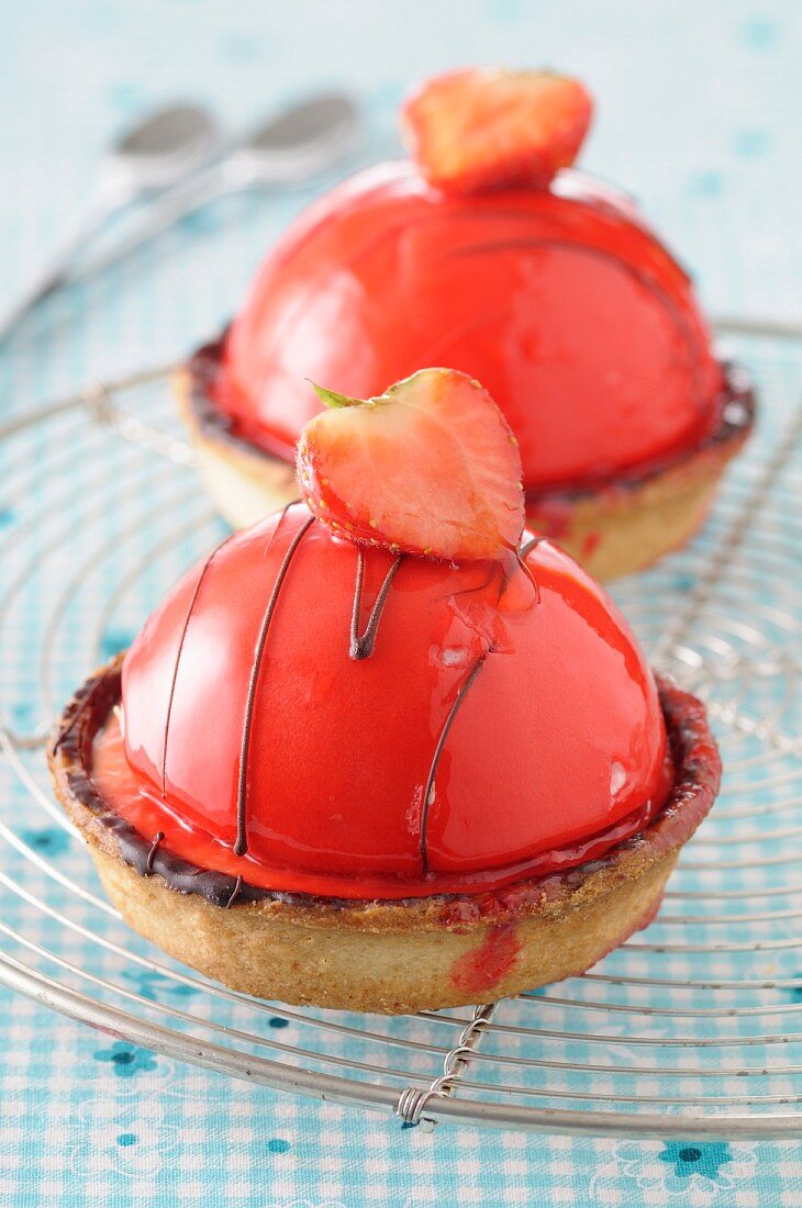 Strawberry dome tartlets on a wire rack