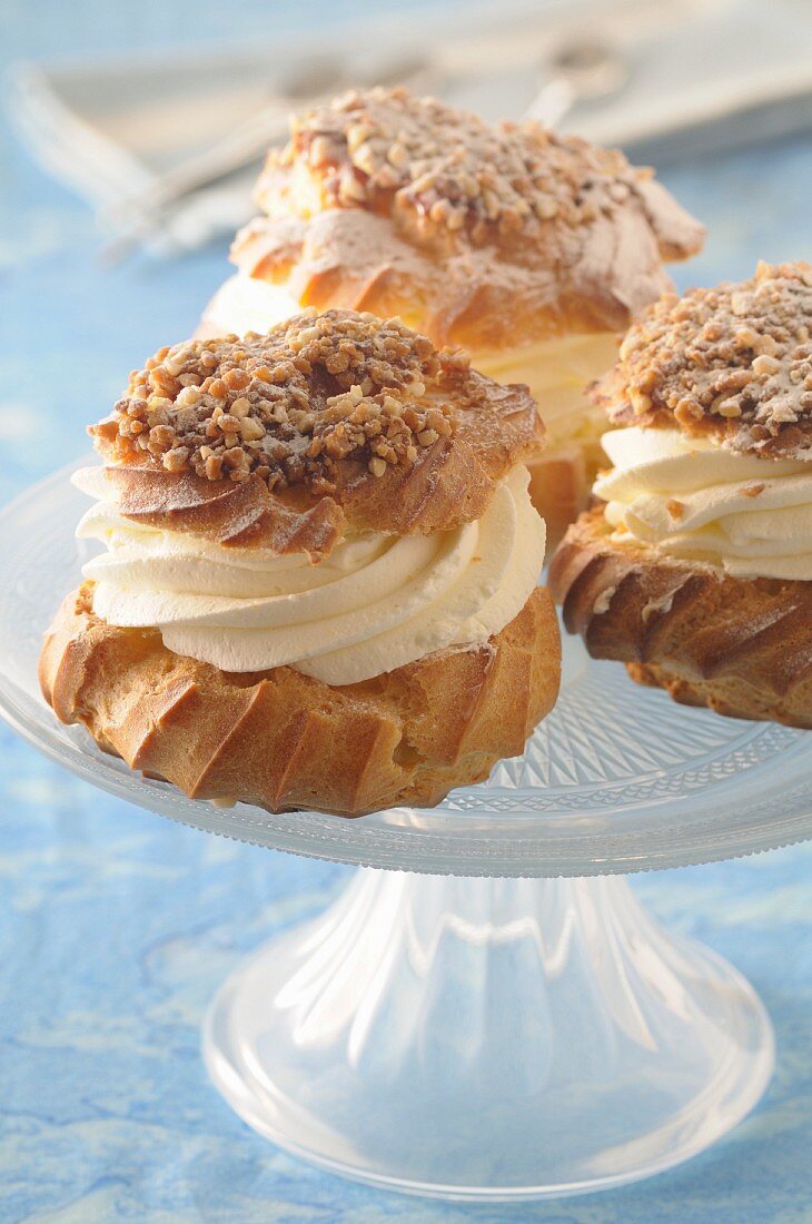 Profiteroles filled with cream on a cake stand