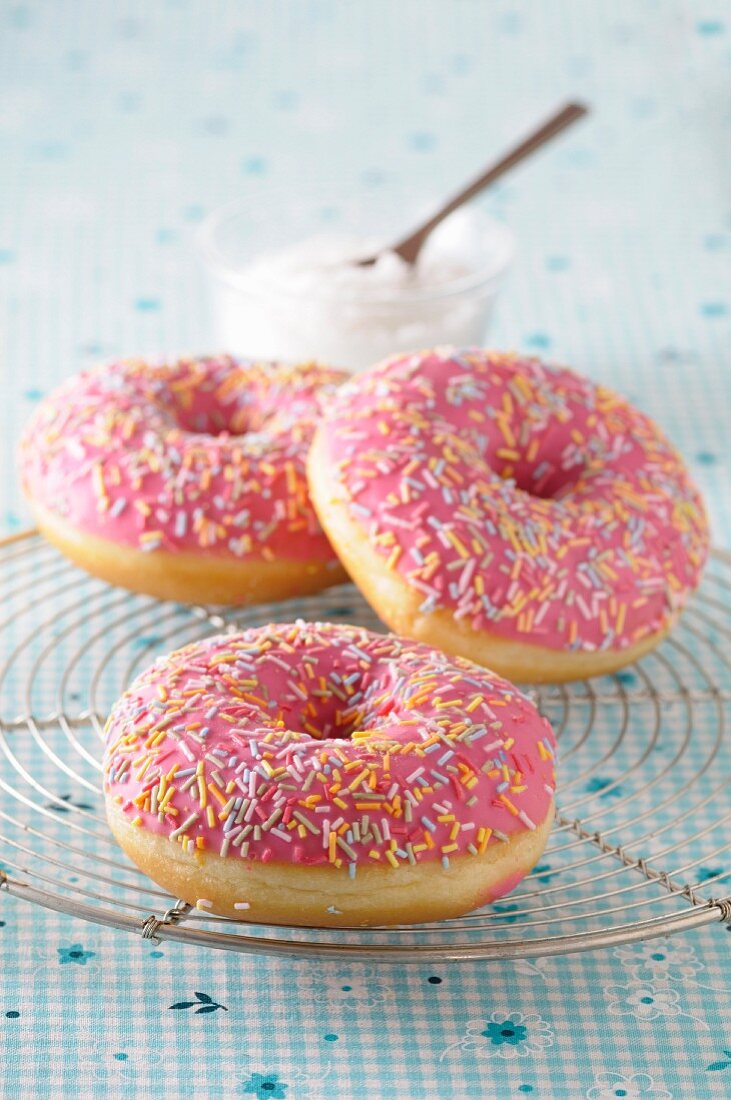 Pink glazed doughnuts with sugar sprinkles