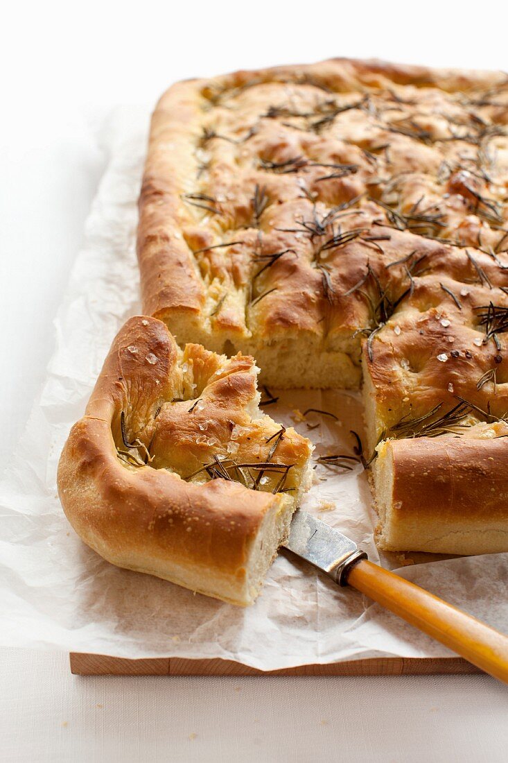 Close up of focaccia bread with herbs, sliced