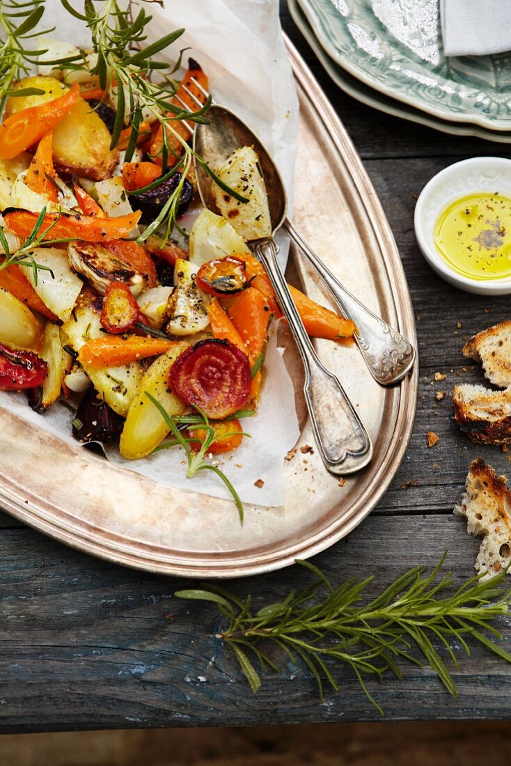 Oven-roasted vegetables with rosemary on a silver platter