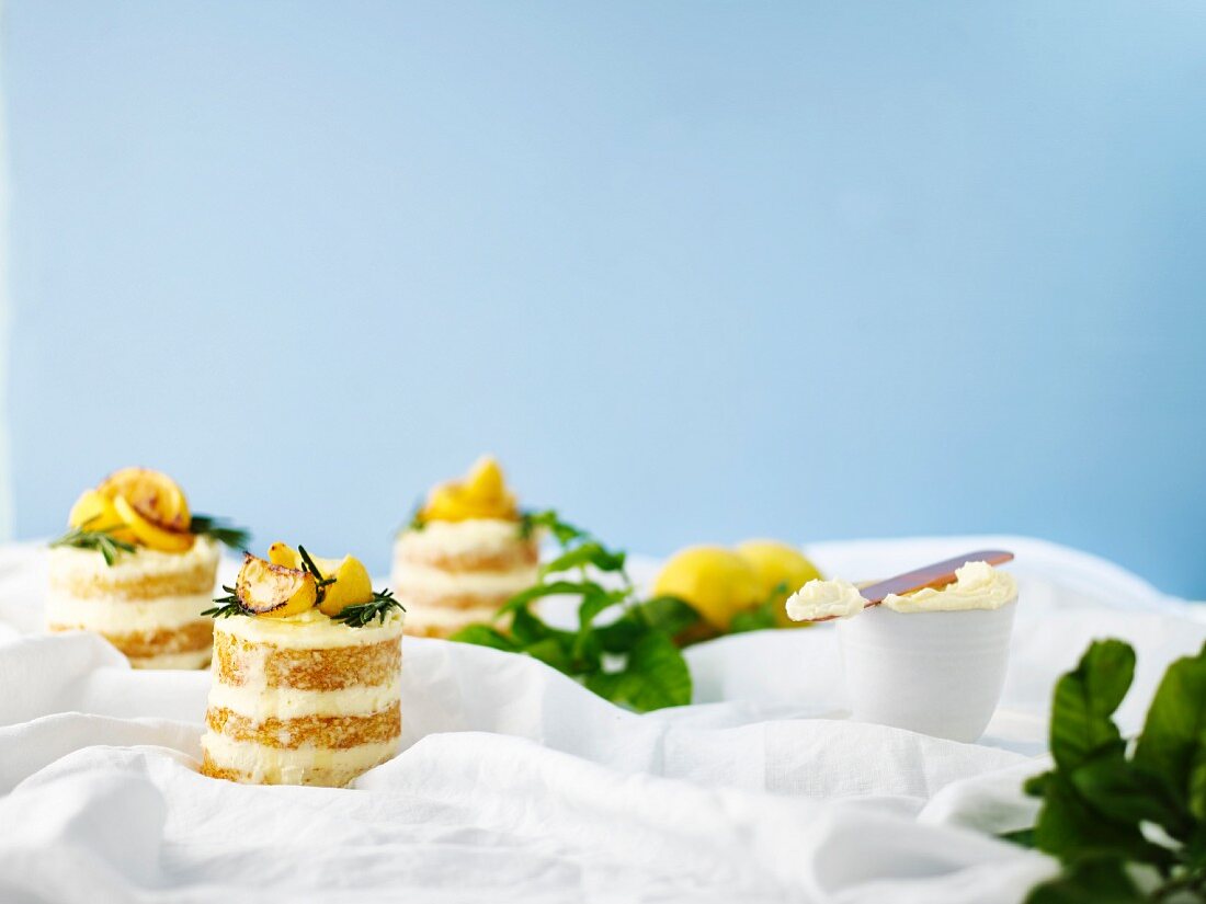 Lemon and olive oil layered cakes with cream cheese frosting and rosemary