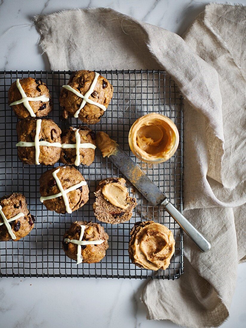 Hot cross buns on a wire rack with macadamia nut butter
