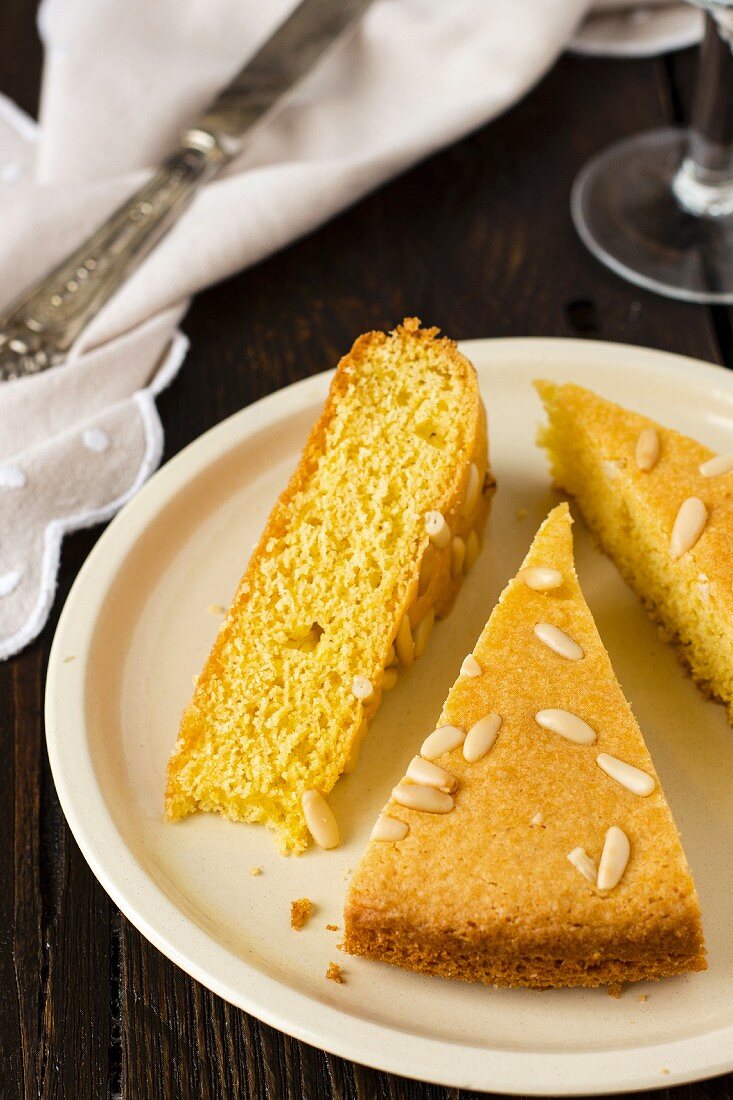 Three slices of pine nut cake on a plate