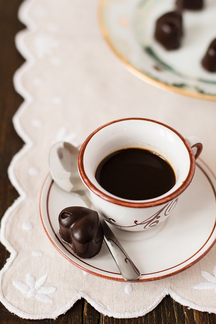 Coffee and heart-shaped chocolate pralines