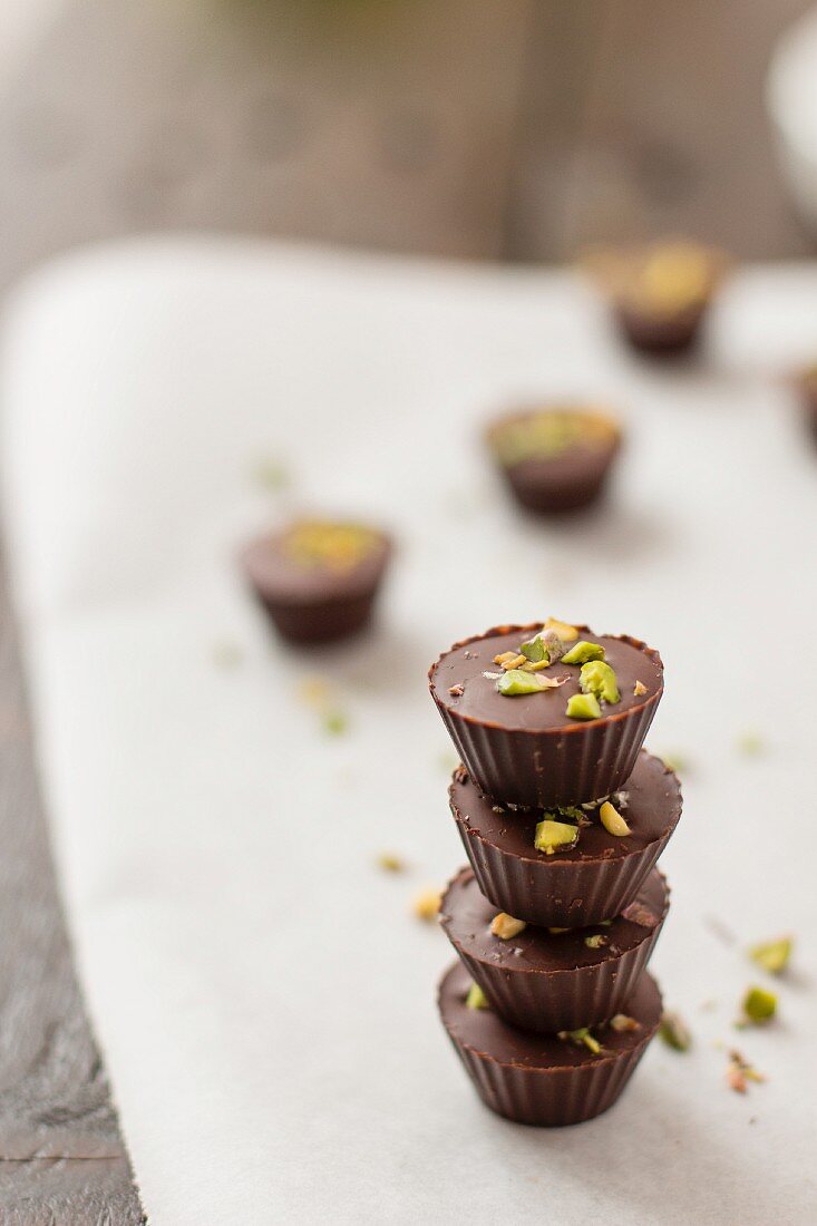 A stack of chocolate bites with pistachio nuts