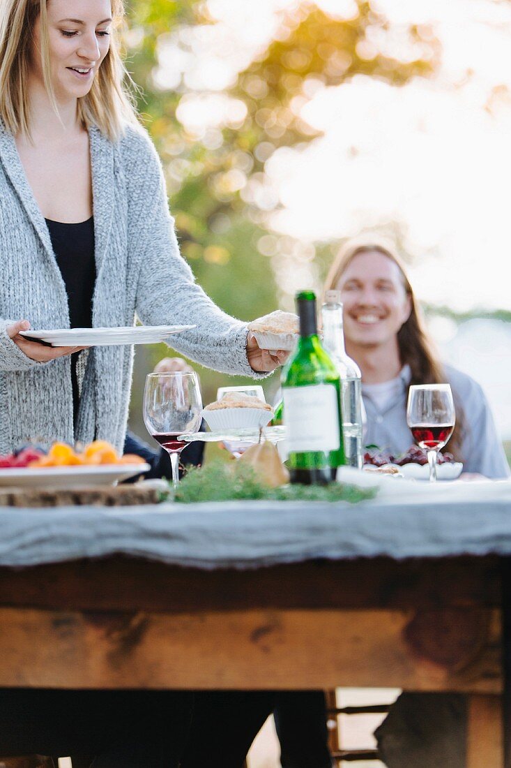 A man and a woman eating outside at an autumnal decorated table