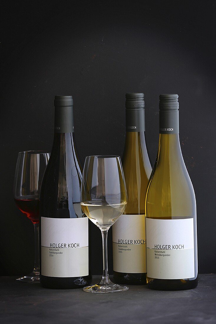 Various wines from the Holger Koch vineyard in bottles and glasses