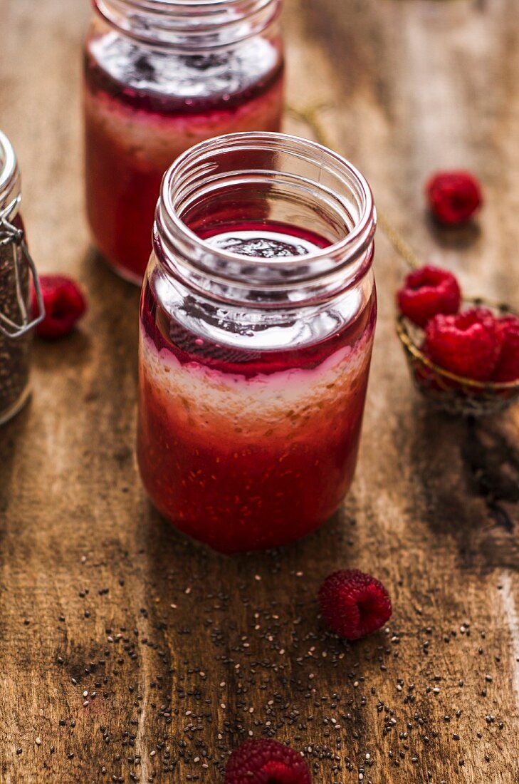 Homemade yogurt with raspberry puree and chia seeds in jars