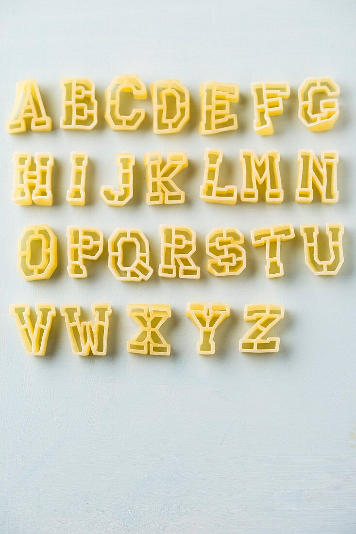 Alphabet pasta on a white surface