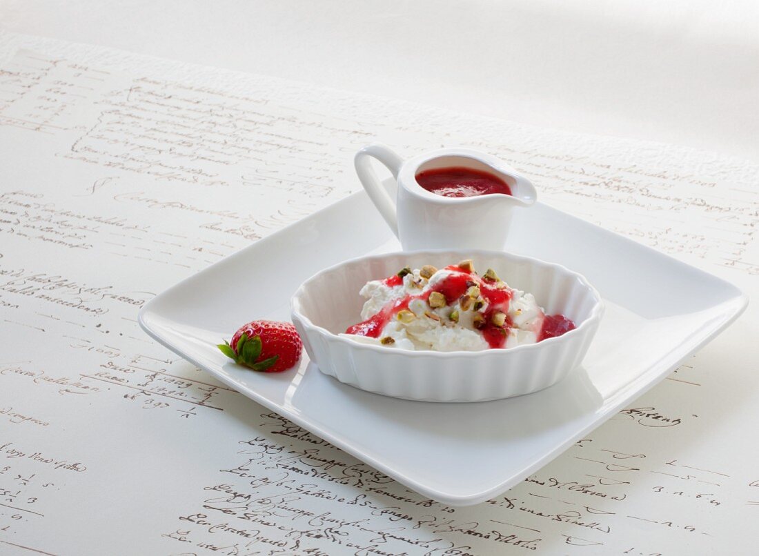 Greek yoghurt with pistachio nuts and strawberry sauce