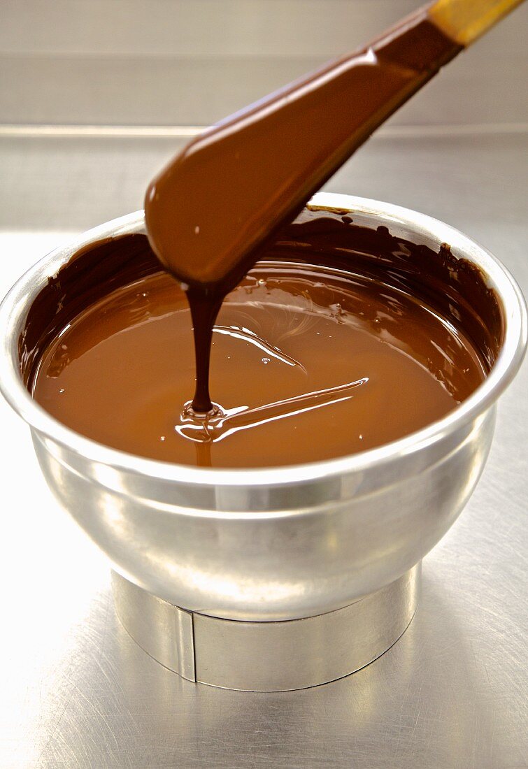 Tempered chocolate in a stainless steel bowl