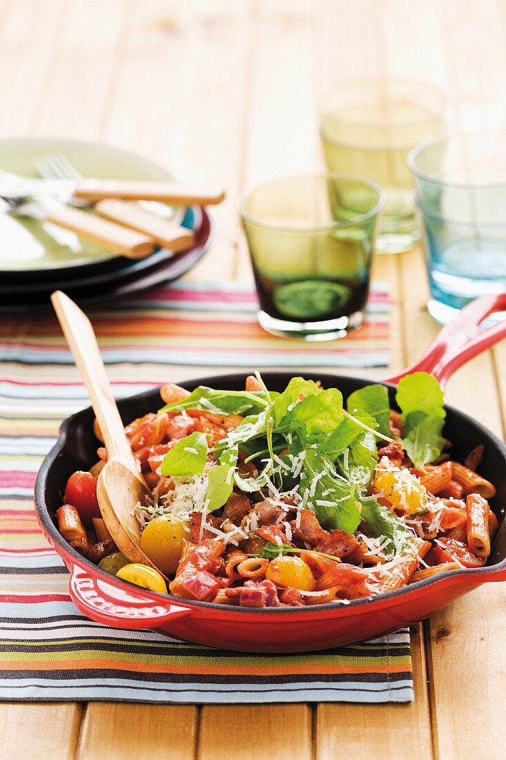 Penne pasta with bacon, cheese and cherry tomatoes