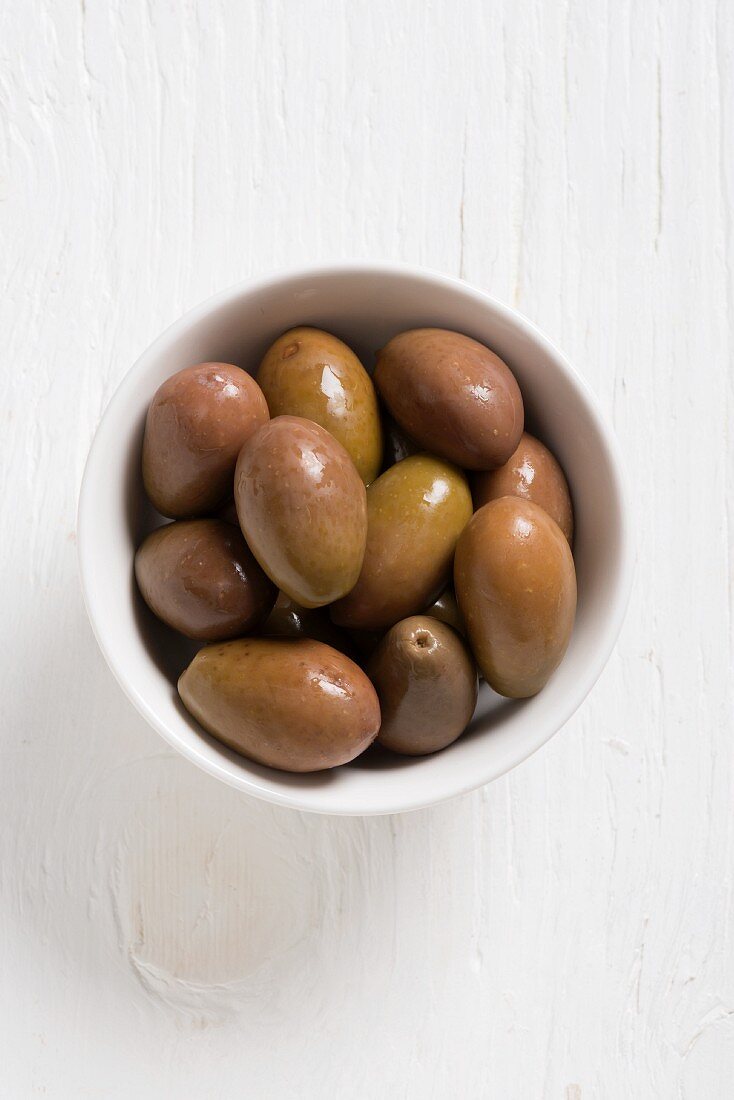 Green olives in a white bowl