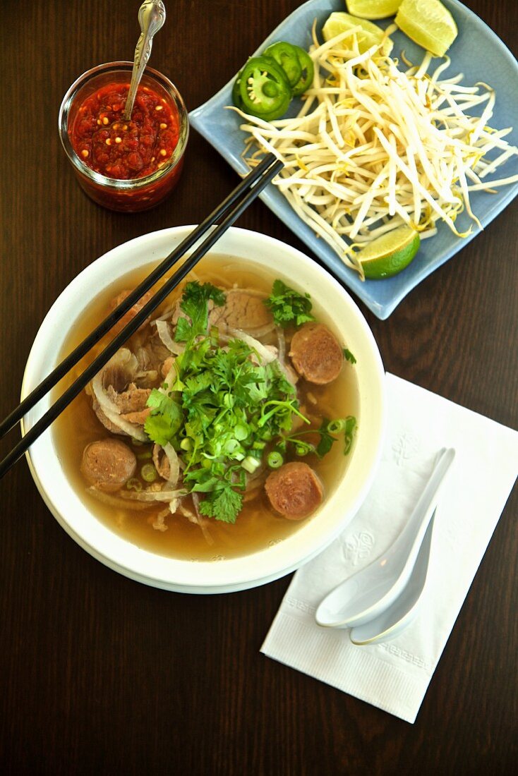 Pho Dac Biet (new soup, Vietnam's) with beef, rice noodles, bean sprouts, limes and basil