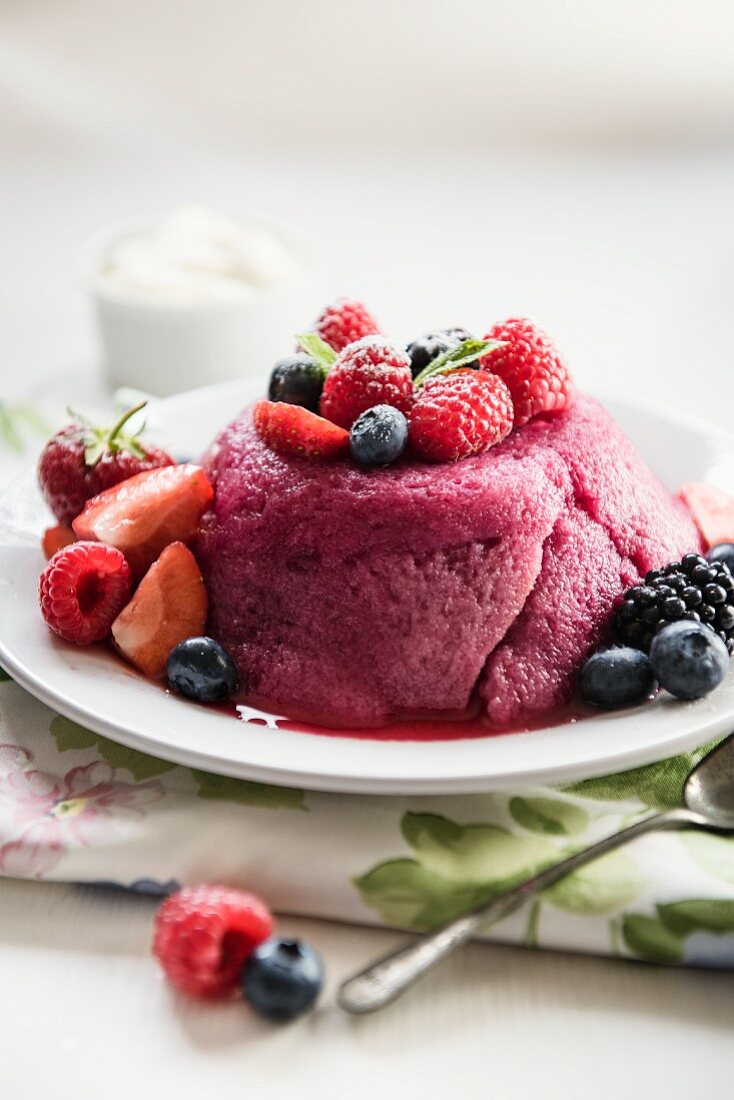 Summer pudding on a plate with fresh berries