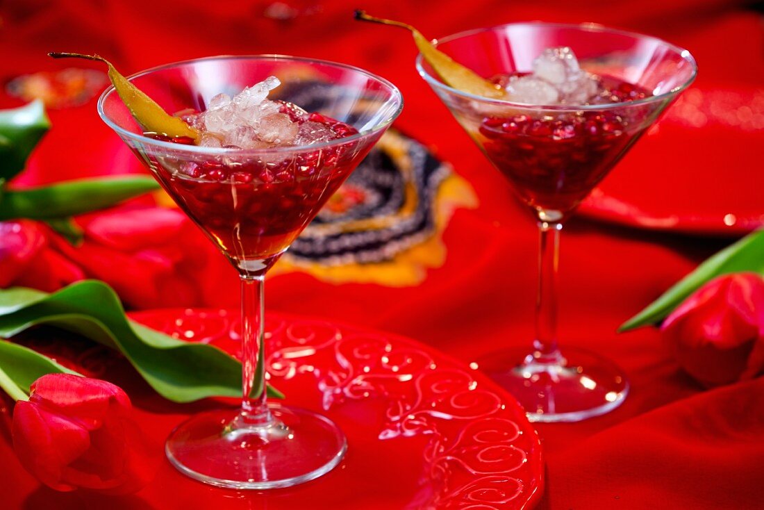 Two cocktails with pomegranate seeds