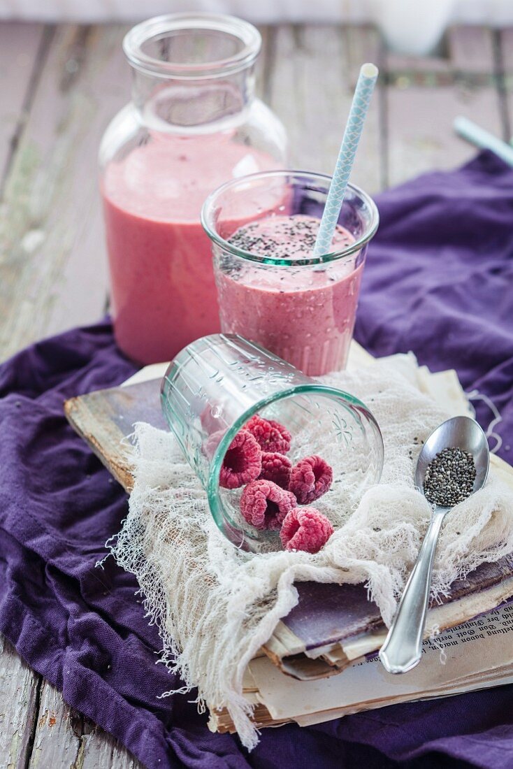 A vegan raspberry smoothie with chia seeds in a bottle and glass