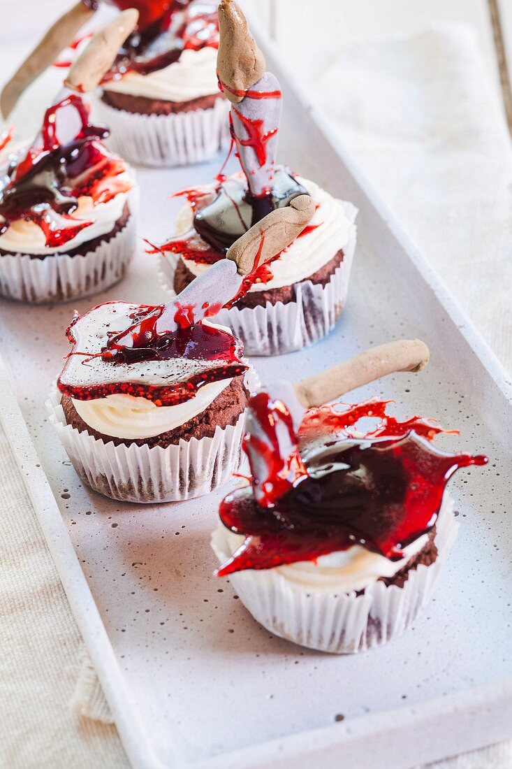 Halloween cupcakes decorated with axes in jelly 'blood'