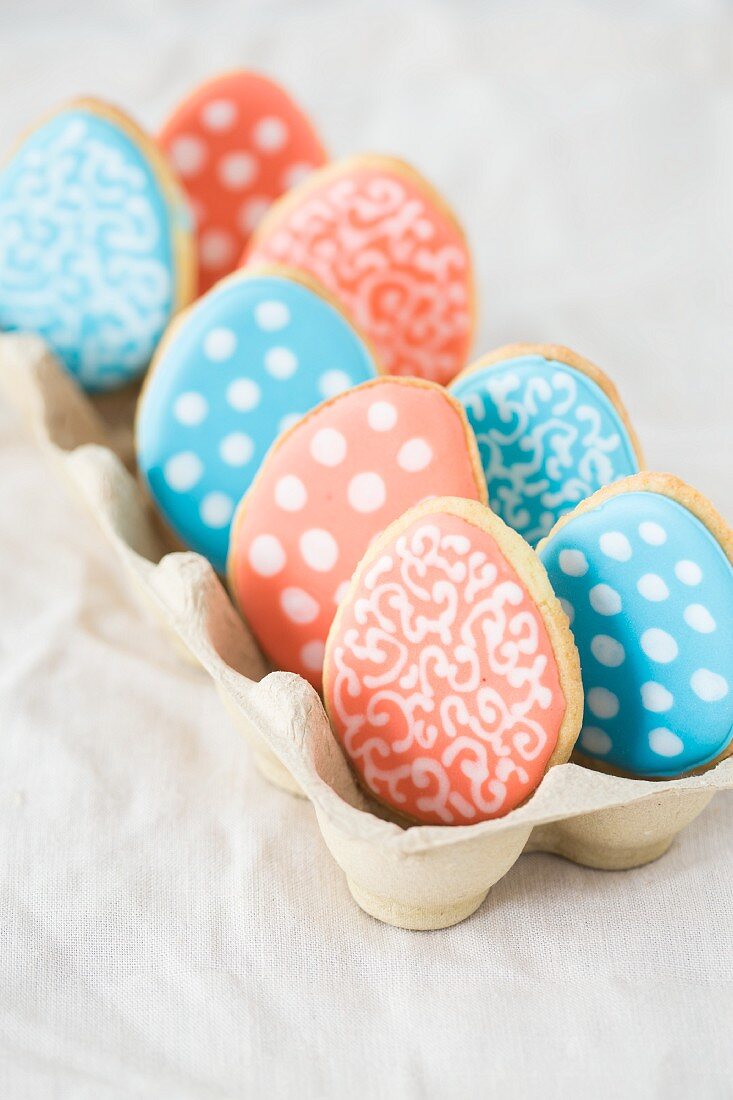 Colourful Easter egg biscuits in an egg box