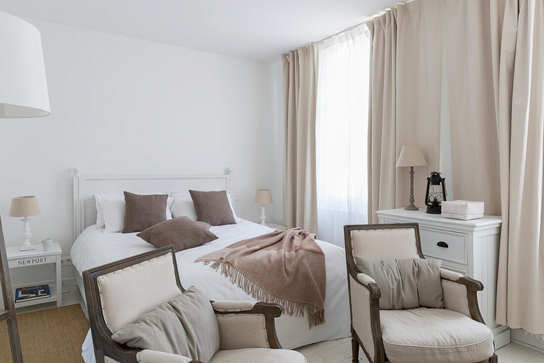 Armchairs in elegant, country-house bedroom