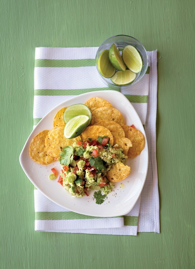 Guacamole with nachos and limes