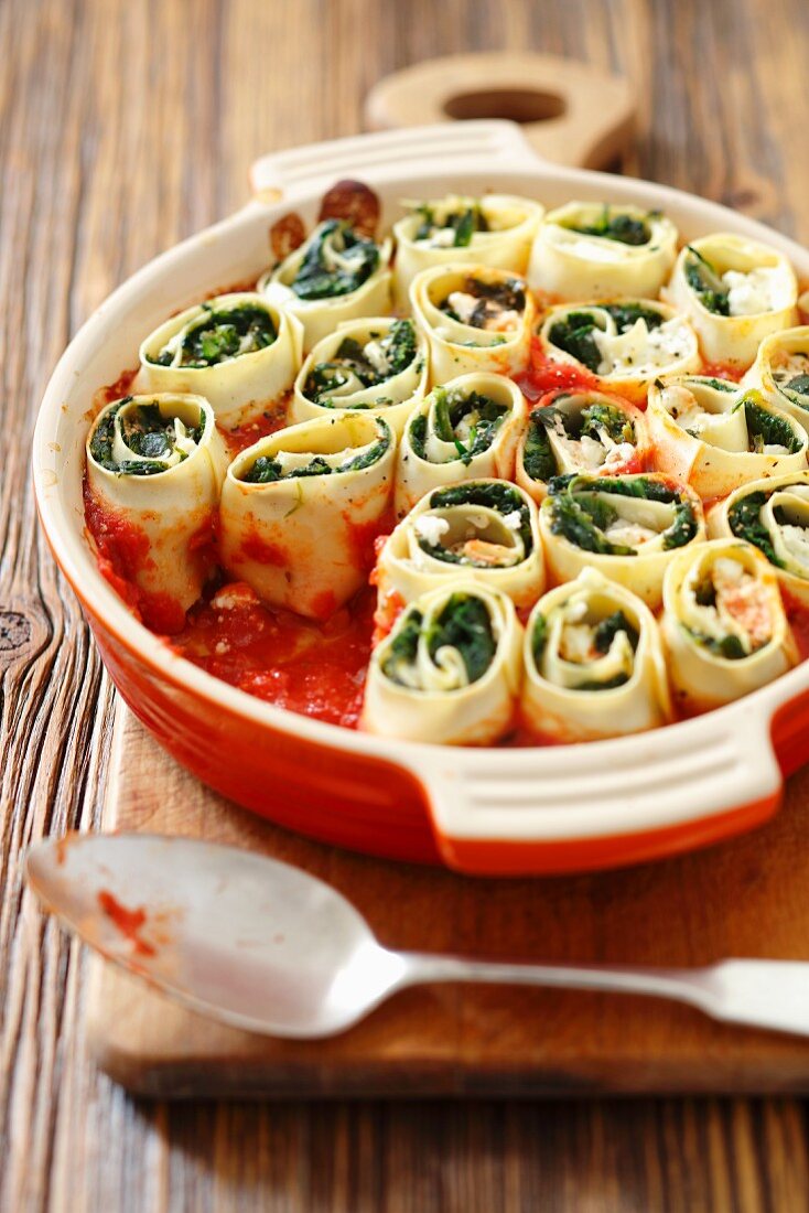 Pasta rolls with spinach and feta cheese in tomato sauce