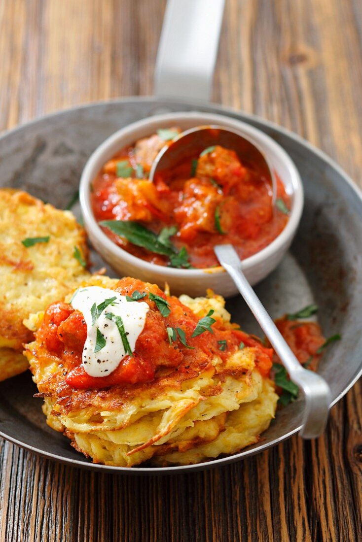 Potato fritters with pork goulash and sour cream