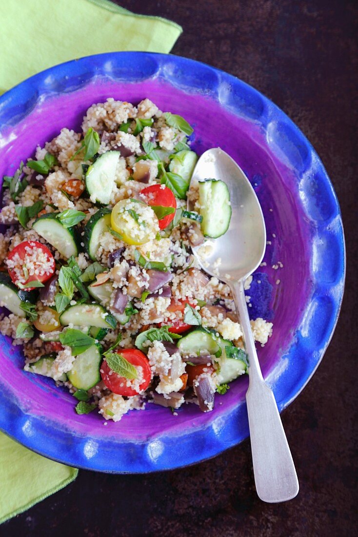 Couscous salad with aubergine, cherry tomatoes, cucumber and herbs