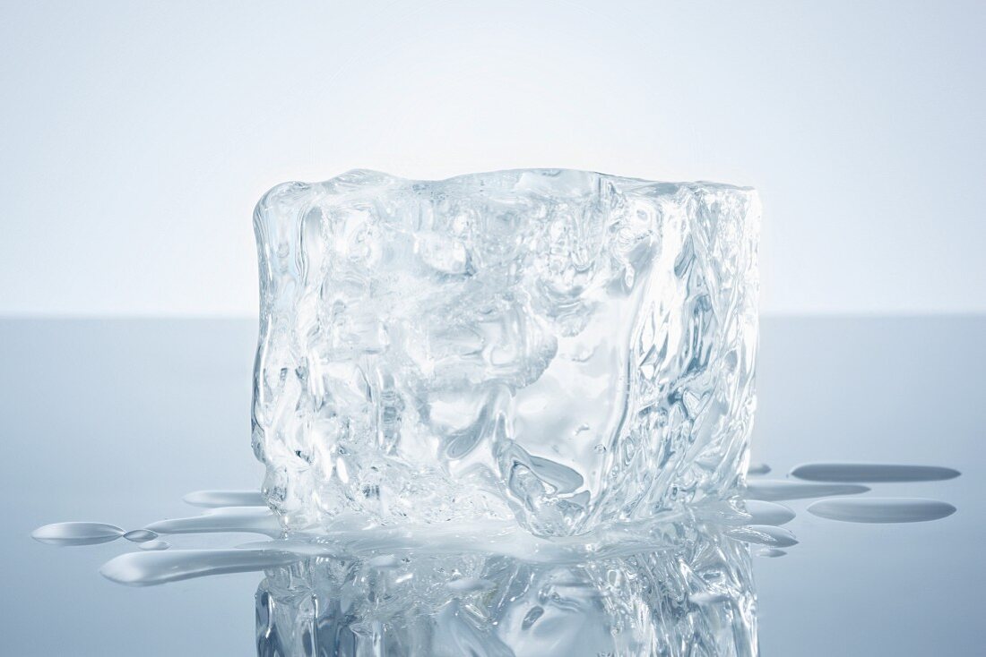 A block of ice on a reflective surface