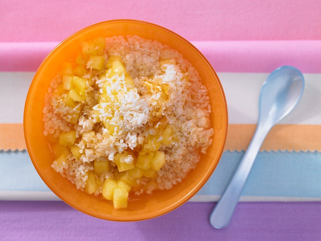 Millet and coconut muesli with fresh pineapple (seen from above)